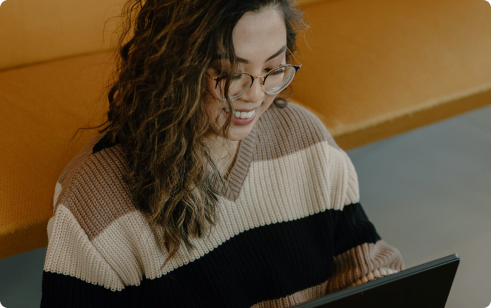 Woman in sweater at computer